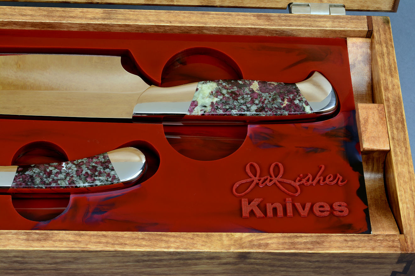 "Concordia and Sanchez" Custom Chef's Knives, silicone prise detail  in CPM 154CM powder metal technology martensitic stainless steel blades, 304 austenitic stainless steel bolsters, Eudialite and Red Jasper gemstone handles, high strength, hand-dyed, hand-cast silicone rubber prise, hardwood case in maple, bird's eye maple, American black walnut, 304 stainless steel, neoprene feet