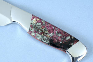 "Concordia" obverse side gemstone handle detail in Eudialite gemstone from Russia, 304 austenitic stainless steel bolsters