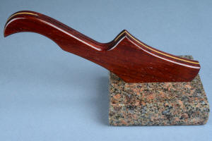 "Falcate" chef's knife with stand view in in paduk and ash hardwoods, paradiso classico granite base